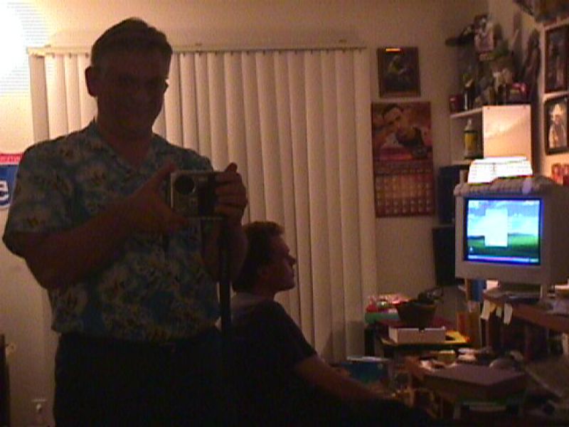 Don Colton taking a picture in a mirror.  Joseph at computer.